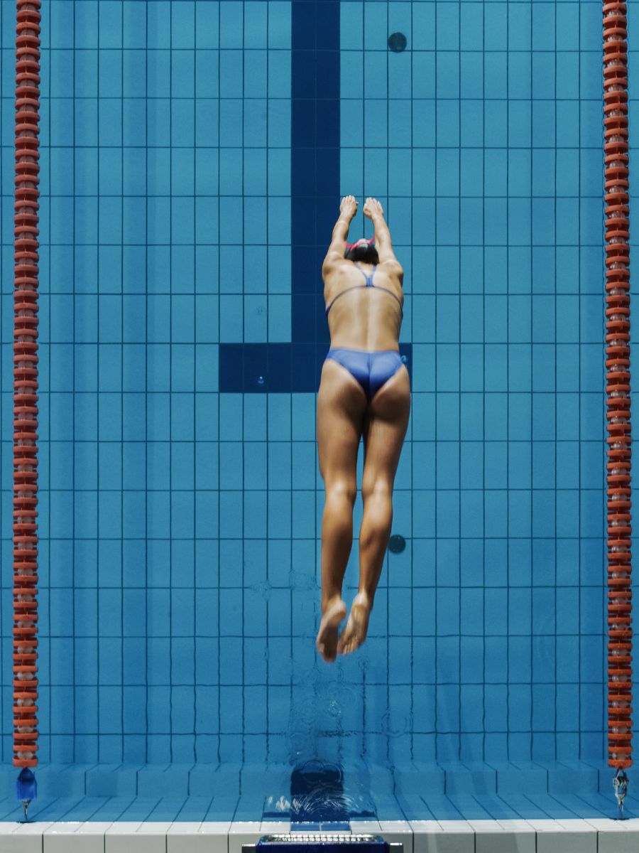 Teenage girl diving into water