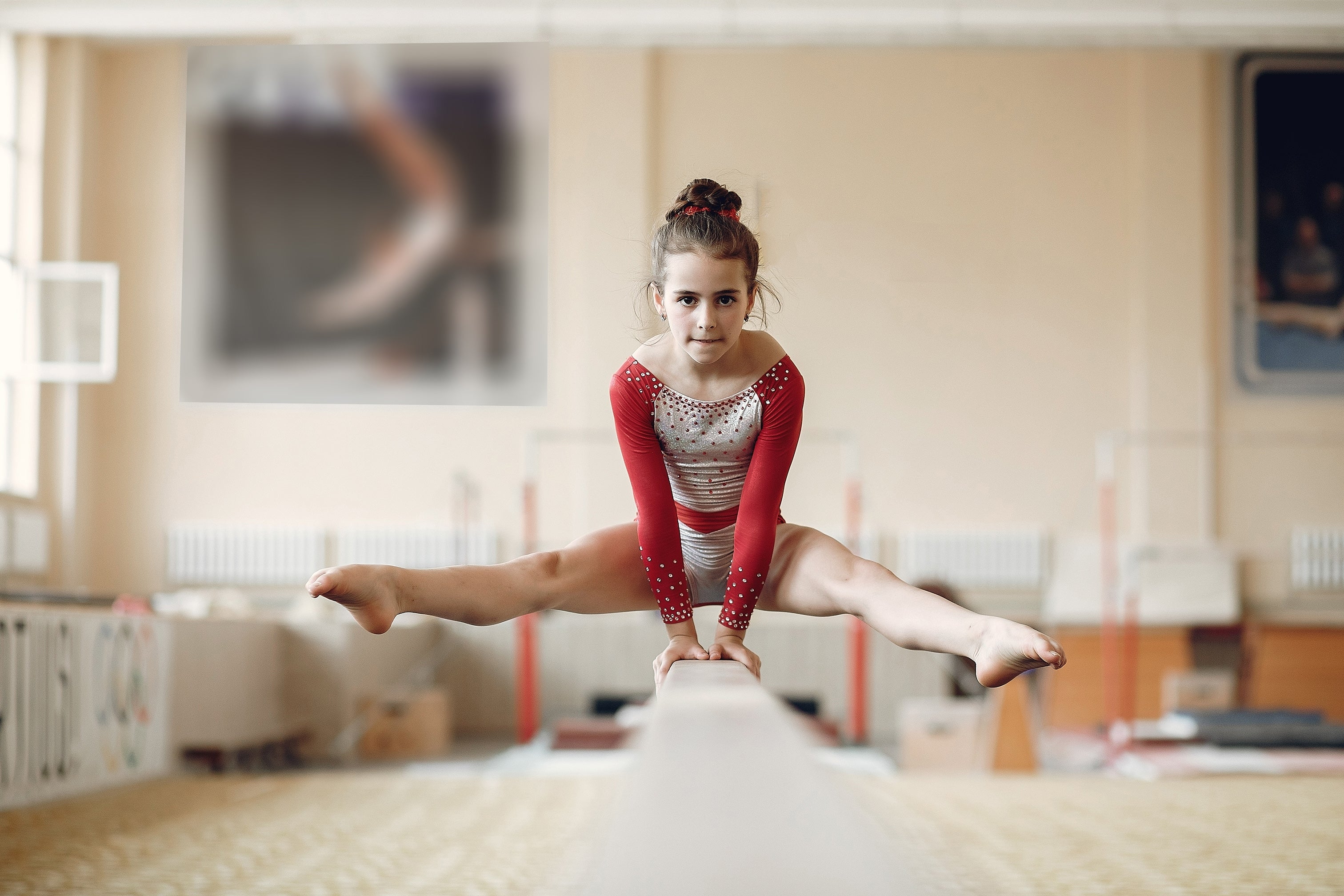Young girl doing gymnastics on bar